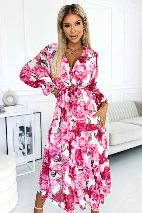 Sukienka Valentina to elegancka kreacja midi z kwiatowym wzorem w odcieniach różu i bieli, idealna na wiosenne i letnie okazje. Sukienka Valentina charakteryzuje się zwiewnym materiałem i wiązaniem w talii, co podkreśla kobiecą sylwetkę.