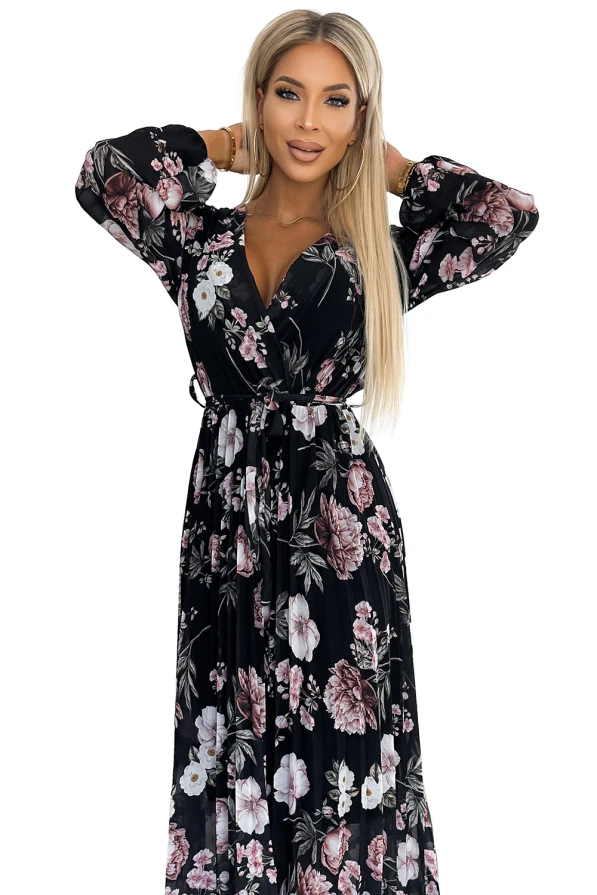 Melna midi kleita ar plīsu un ziedu rakstu, kas piešķir eleganci un sievišķību. Kleitai ir garas piedurknes un josta, kas izceļ vidukli.