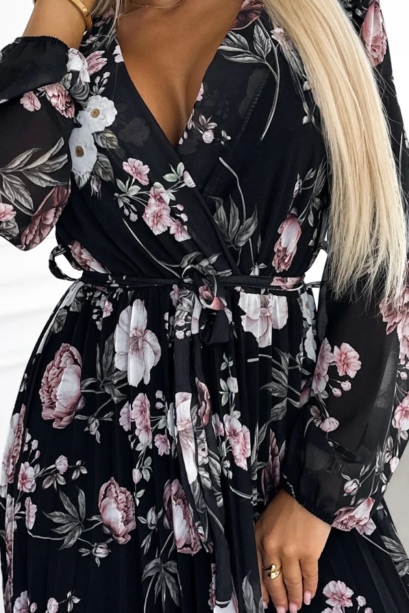 Eleganta melna midi kleita ar ziedu rakstu un plīsu detaļām, kas piešķir tai sievišķīgu šarmu. Kleitai ir garas piedurknes un josta, kas izceļ vidukli.